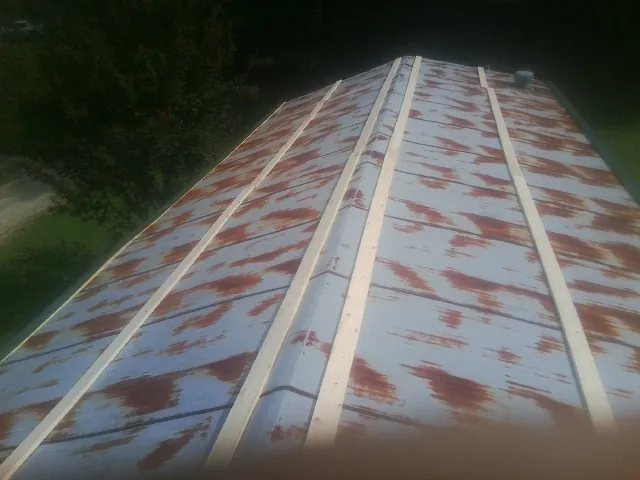 Rusted metal roof panels with new wood purlins before replacement — Storm Damage Roof Repair in Glenford by Roofing Brothers